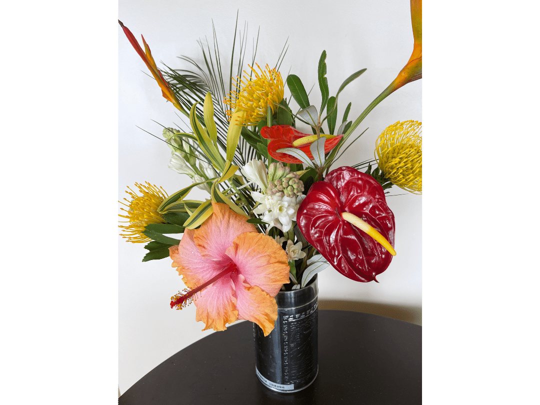 striking bouquet in vase includes tropical hibiscus and other tropical flowers